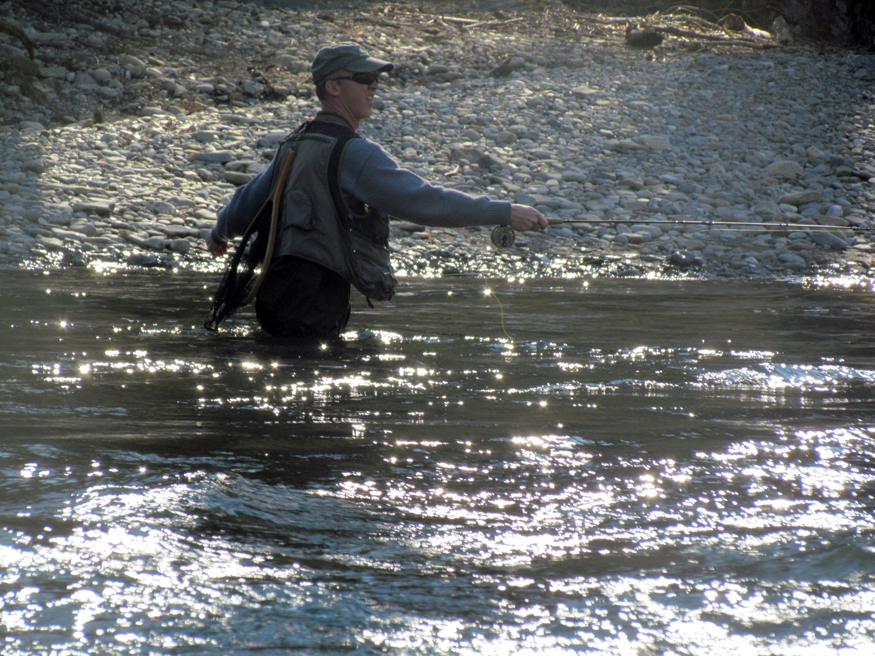 fisherman in mountain river