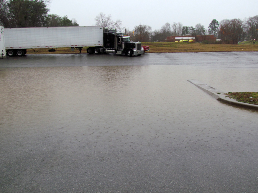 tractor trailer driving into flooded streets