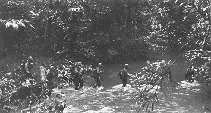 Marines cross a stream on New Georgia